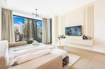 a large white bedroom with a large window at Stylish 2BR Downtown Dubai with Skyline & Burj Khalifa Views in Dubai