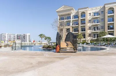 a bench in front of a large building at FIRST CLASS Studio Elegant Escape, Cozy Luxe in Dubai