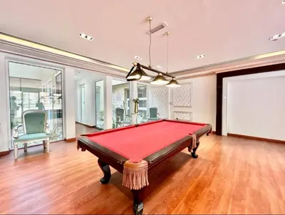 a pool table in a living room with avertisementatronatronatronstrationstrationstration at FIRST CLASS Studio Elegant Escape, Cozy Luxe in Dubai