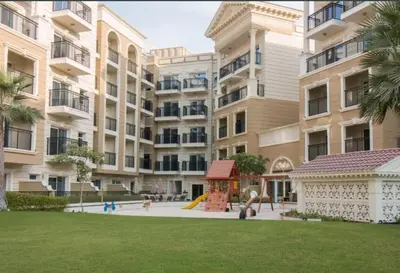 an apartment building with a playground in front of it at FIRST CLASS Studio Elegant Escape, Cozy Luxe in Dubai
