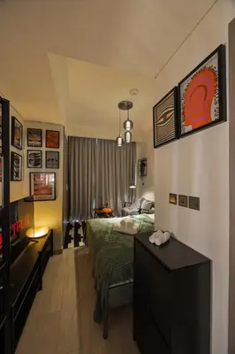 a bedroom with a bed and a desk in it at Elite Escapes - Boy Girl Apartment Edition in Dubai