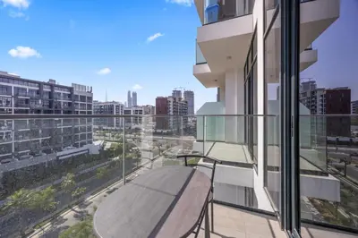 a balcony with a table and a view of a city at Elite Escapes - Boy Girl Apartment Edition in Dubai