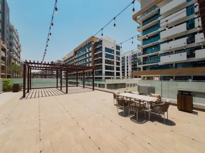 a patio with a table and benches on a building at Elite Escapes - Boy Girl Apartment Edition in Dubai