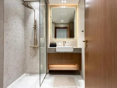 a bathroom with a sink and a shower at Peaceful Studio Stay Canal Views Poolside Comfort in Dubai