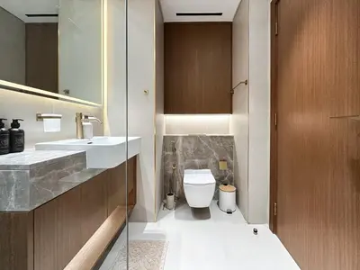 a bathroom with a sink and a toilet at Peaceful Studio Stay Canal Views Poolside Comfort in Dubai
