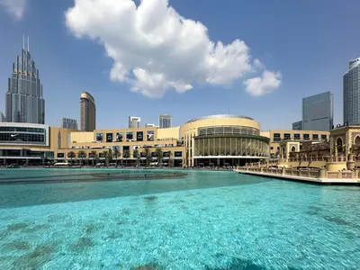 a large building with a large pool of water at Peaceful Studio Stay Canal Views Poolside Comfort in Dubai