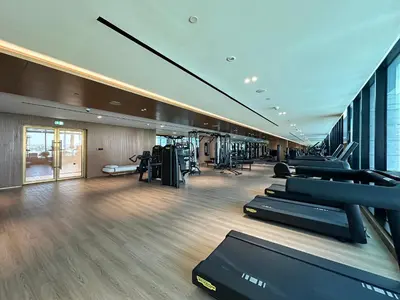 a gym with a row of treadmills and machines at Peaceful Studio Stay Canal Views Poolside Comfort in Dubai
