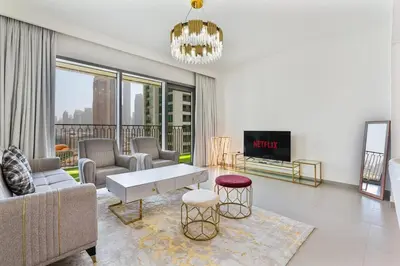 a living room with a couch and a table at 3BR APT with Burj View from Balcony - Pool and Gym in Dubai