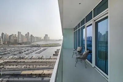 a balcony of a building with a view of a marina at 4BR Beachfront Marina & Palm View in Dubai
