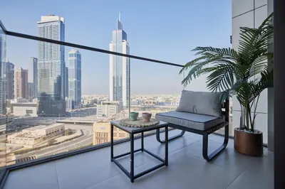 a chair on a balcony with a view of a city at Cozy 1BR Burj Crown Downtown in Dubai