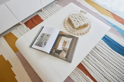 a white table with a picture and a photograph on it at Cozy 1BR Burj Crown Downtown in Dubai