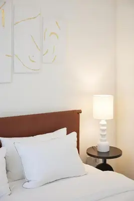 a bed with a white pillow and a lamp on a table at Cozy 1BR Burj Crown Downtown in Dubai