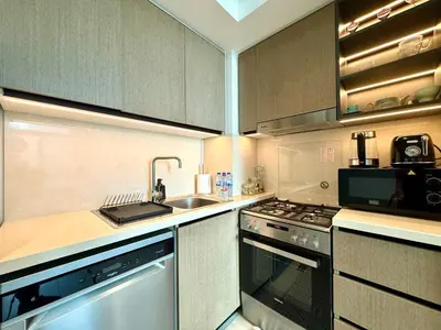 a kitchen with a sink and a stove at Cozy 1BR Burj Crown Downtown in Dubai