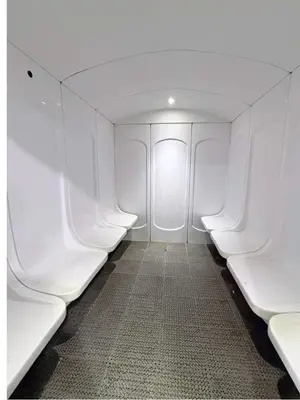 a row of white seats in an airplane at Capital Bay city view Studio in Dubai