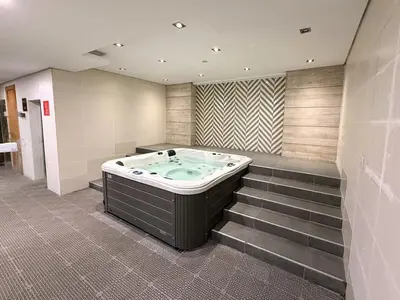 a jacuzzi tub in a room with stairs at Capital Bay city view Studio in Dubai
