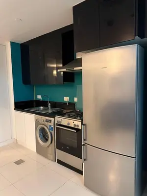 a kitchen with a stainless steel refrigerator and a dishwasher at Capital Bay city view Studio in Dubai