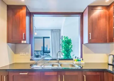 a kitchen with a sink and a large window at Exceptional 1BR I Burj Khalifa I Fountain View in Dubai