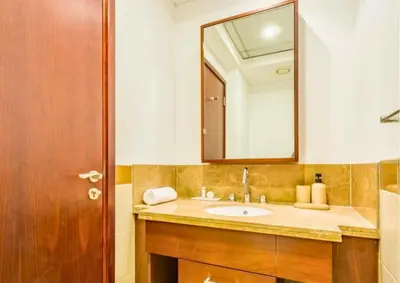 a bathroom with a sink and a mirror at Exceptional 1BR I Burj Khalifa I Fountain View in Dubai