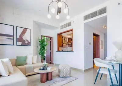 a living room with a couch and a table at Exceptional 1BR I Burj Khalifa I Fountain View in Dubai