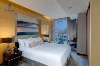 a bedroom with a white bed and a large window at Exclusive 1BDR Near Burj Khalifa with Free Parking in Dubai