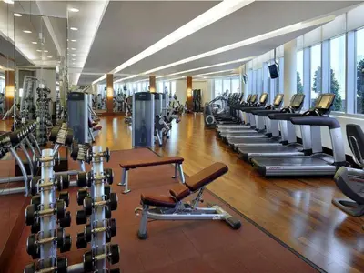 a gym with a row of treadmills and machines at Exclusive 1BDR Near Burj Khalifa with Free Parking in Dubai