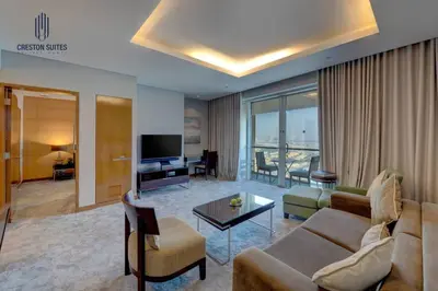 a living room with a couch and a television at Exclusive 1BDR Near Burj Khalifa with Free Parking in Dubai