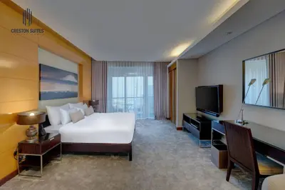 a hotel room with a bed and a flat screen tv at Exclusive 1BDR Near Burj Khalifa with Free Parking in Dubai