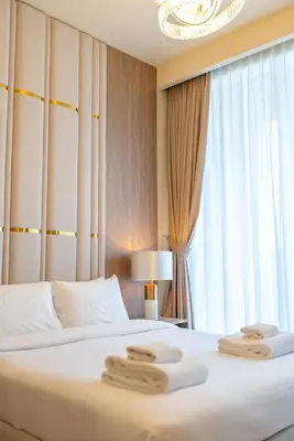a bedroom with a bed with two towels on it at On the dock Nice 1bedroom in Dubai Creek Harbour in Dubai
