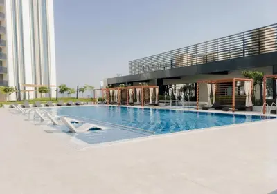 a large swimming pool in front of a building at On the dock Nice 1bedroom in Dubai Creek Harbour in Dubai