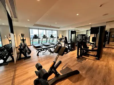 a gym with several treadmills and machines in a room at Downtown Escape 2bedroom Apartment 4 guests Dubai in Dubai
