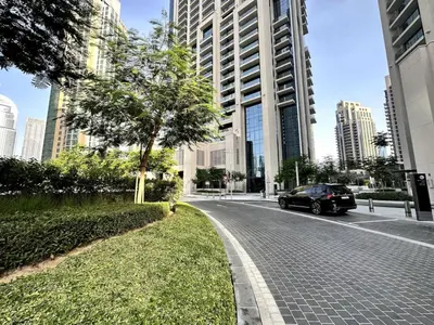 a car parked on a street with tall buildings at Downtown Escape 2bedroom Apartment 4 guests Dubai in Dubai