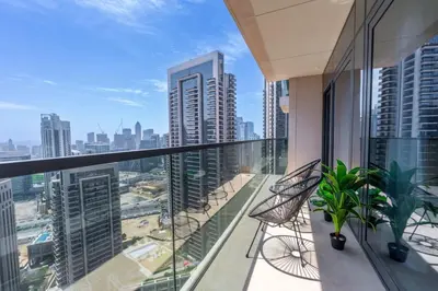 a balcony with chairs and a view of the city at Downtown Escape 2bedroom Apartment 4 guests Dubai in Dubai