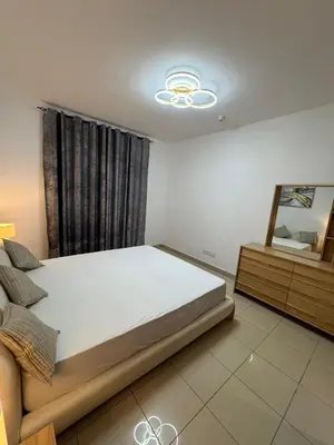 a bedroom with a large bed and a mirror at Apartments on Marina in Dubai