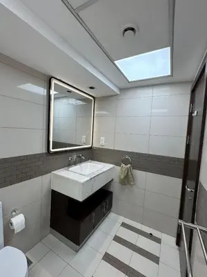 a bathroom with a sink and a mirror at Apartments on Marina in Dubai