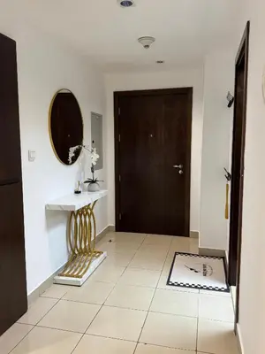 a hallway with a door and a table and a mirror at Apartments on Marina in Dubai
