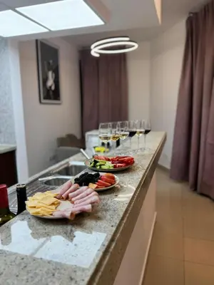 a counter with plates of food and glasses of wine at Apartments on Marina in Dubai