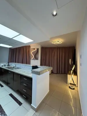 a kitchen with a large island in a room at Apartments on Marina in Dubai