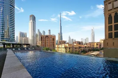 a large swimming pool with a city skyline in the background at Elegant 3-Bedroom Apartment - Panoramic Burj Khalifa and Downtown Views in Dubai