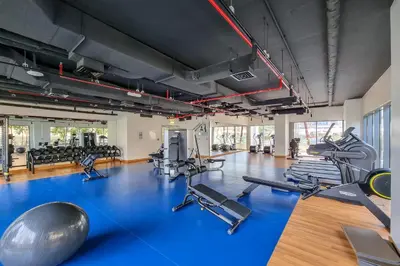 a gym with several treadmills and exercise machines at Elegant 3-Bedroom Apartment - Panoramic Burj Khalifa and Downtown Views in Dubai