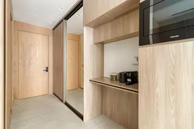 a room with a kitchen with a counter and a television at Modern Studio Near Burj Khalifa & Dubai Mall with Pool, Gym, Concierge & Parking in Dubai