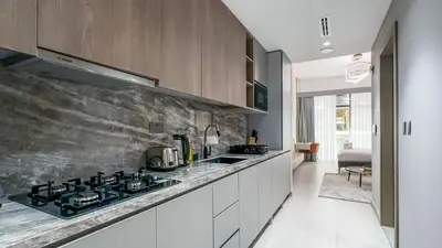 a kitchen with a stove and a counter top at Modern Studio in JVC, Rooftop Pool & Gym Access - 10AB08 in Dubai