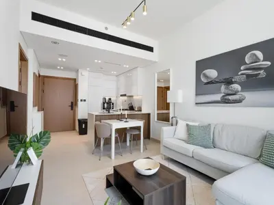 a living room with a couch and a table at Luxe Escape - Stylish 1BR in Binghatti Venus-05 in Dubai
