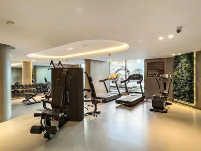 a gym with several treadmills and exercise bikes in it at FIRST CLASS Studio Luxe & Cozy Vibes in Dubai