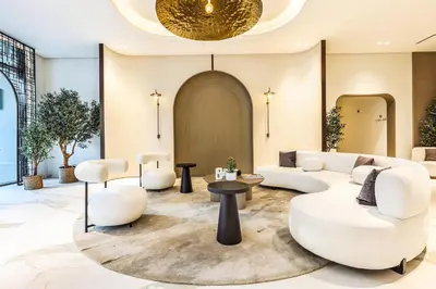 a lobby with white furniture and a gold ceiling at FIRST CLASS Studio Luxe & Cozy Vibes in Dubai
