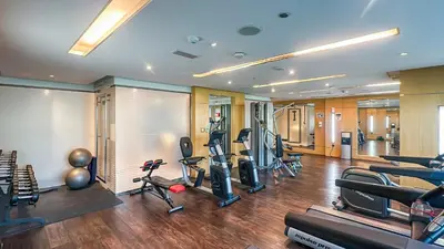 a gym with treadmills and elliptical machines at Cozy Studio with Balcony Overlooking Dubai Canal - 15AB07 in Dubai