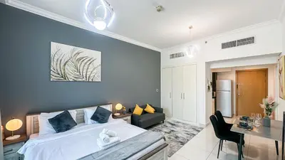 a bedroom with a bed and a living room at Cozy Studio with Balcony Overlooking Dubai Canal - 15AB07 in Dubai