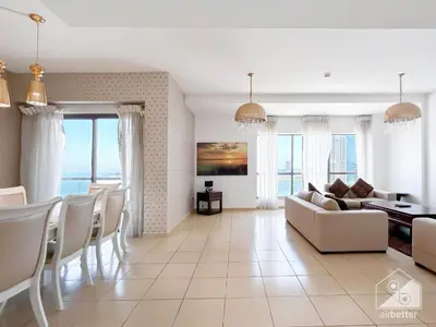a living room with a couch and a table at Stunning 4 bedroom with Breathtaking Sea View JBR in Dubai