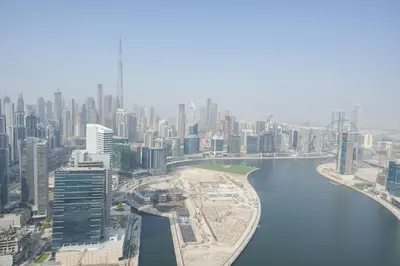 an aerial view of a city with a river at Luxury 2-Bedroom Stay in the Heart of Churchill in Dubai
