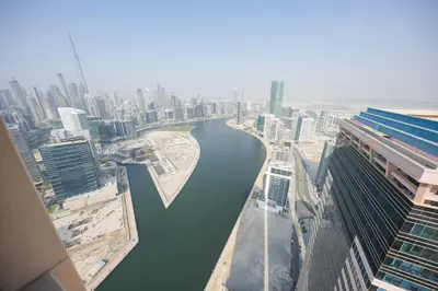 a view of a river in a city with buildings at Luxury 2-Bedroom Stay in the Heart of Churchill in Dubai