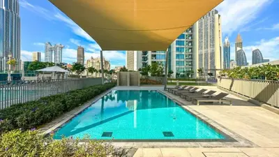 a swimming pool on the roof of a building at TRPS - Downtown Views II Tower 2, Downtown Dubai - 3BR plus Maids - Stylish Apartment Near Burj Khalifa & Attractions in Dubai